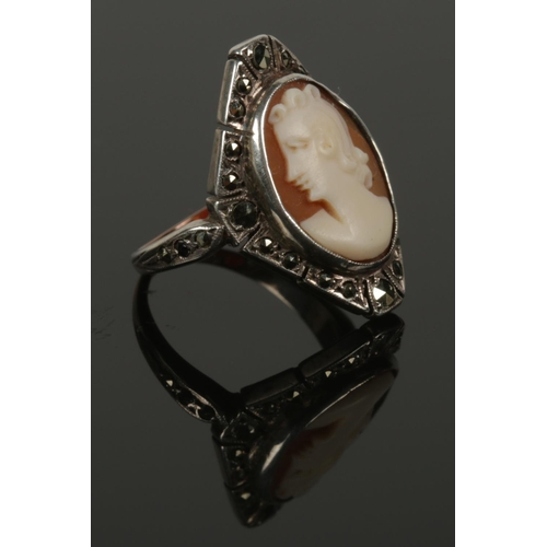 580 - A 9ct gold and silver marcasite cameo ring. Size