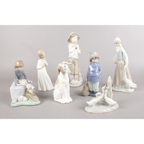 454 - Seven Nao figures. Dog, girl sitting with rabbits, boy with duffle coat & bag examples etc. (29cm ta... 