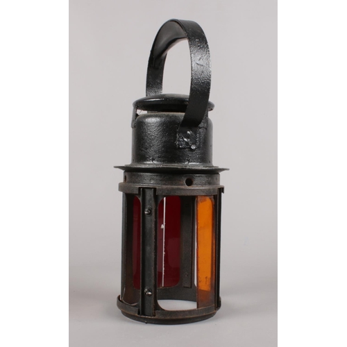 472 - A vintage L.M.S tricolour railway lamp. (33cm height)