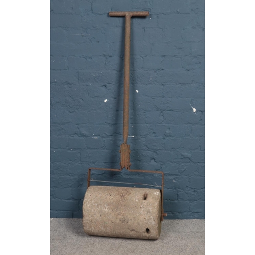 488 - A vintage cast iron and heavy concreate garden roller. H: 140cm, W:44.5cm.