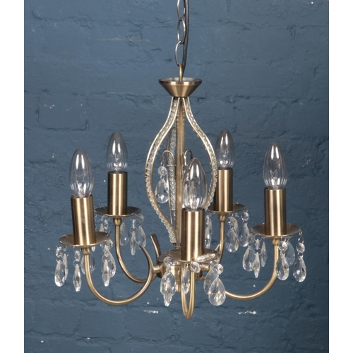 544 - A 5 arm chandelier with crystal style droplets.