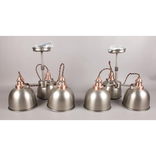 549 - A pair of three armed industrial style ceiling lights. Comprising of copper affect detailing and vin... 