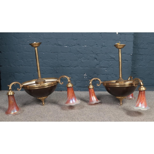 551 - A pair of three armed brass ceiling lights - decorated with glass opalized deep pink shades. H: 63cm... 