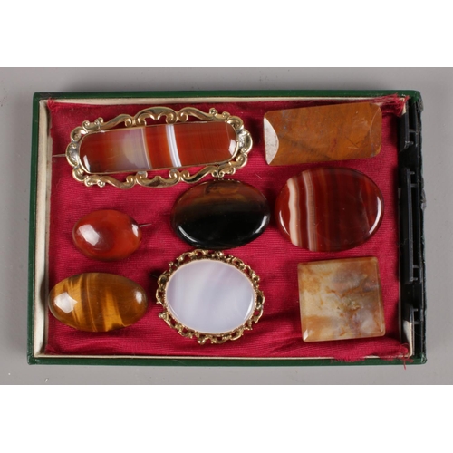 583 - A collection of agate brooches. Includes two with yellow metal mounts.