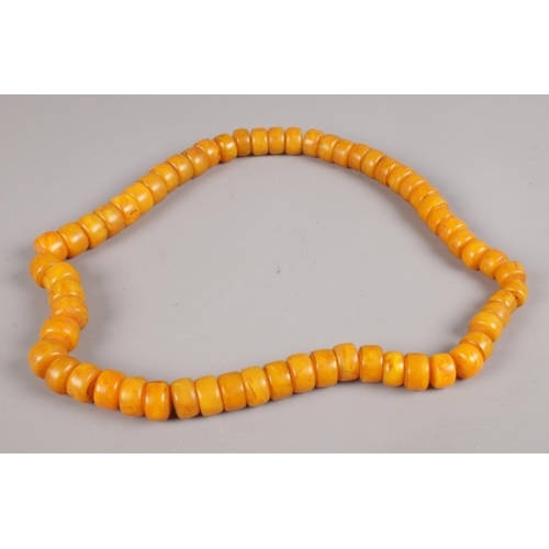 587 - A butterscotch coloured necklace. Length approximately 80cm.