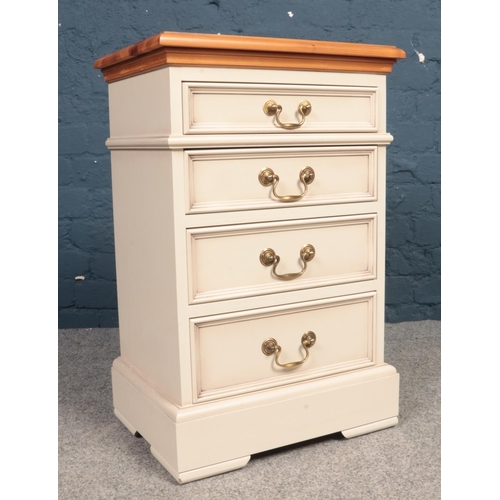 390 - A part painted Pine topped bedside table. Comprising of four drawers and swing handles. H:69cm, W:45... 