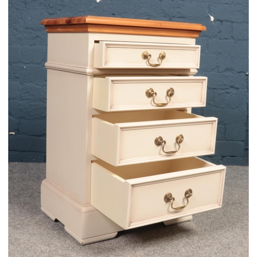 390 - A part painted Pine topped bedside table. Comprising of four drawers and swing handles. H:69cm, W:45... 