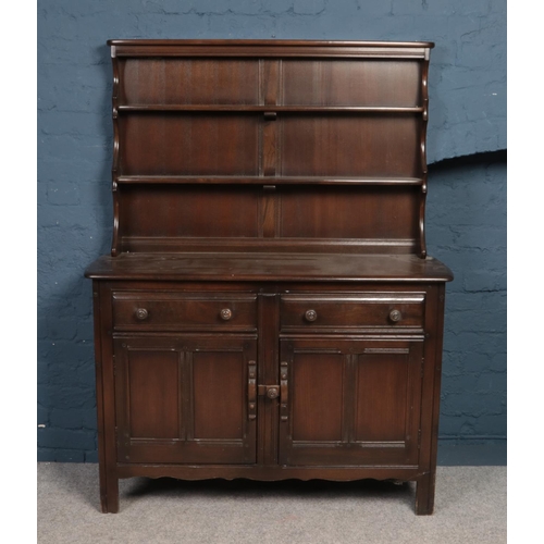 402 - An Ercol panelled dresser.