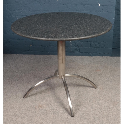 403 - A circular granite topped bistro table & two leatherette chairs. 
Table: H: 75cm, D:90cm.