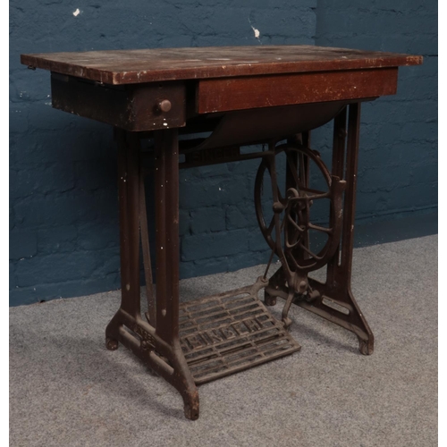 408 - A 'Singer' sewing machine table with named foot peddle. H: 74cm, W:79cm,D:42cm.