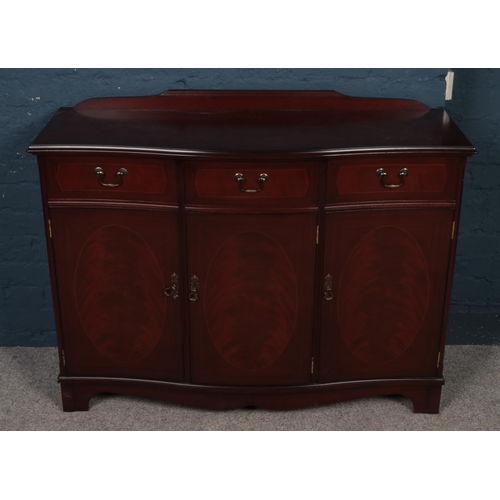 412 - A Mahogany sideboard. Three drawers above cupboards. (116cm width, 84cm height, 37cm depth)