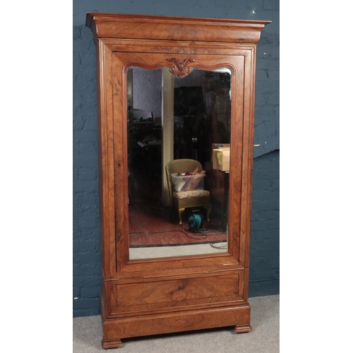 414 - A French figured Walnut carved armoire with single mirrored door. Oak lined. (205cm height, 95cm wid... 