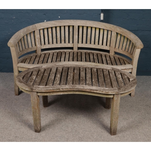 482 - A carved hardwood garden seat and matching table. (height 85cm, width 155cm, depth 64cm).