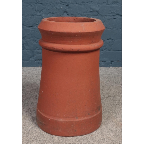 495 - A terracotta chimney pot/garden planter. (Height 47cm).