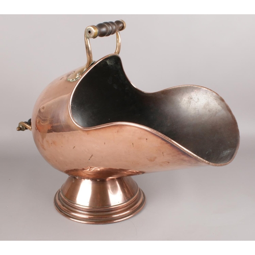 550 - A copper and brass coal scuttle with stepped base.