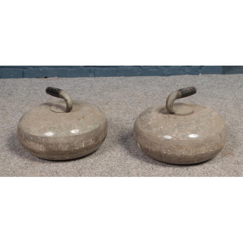 553 - A pair of curling stones.