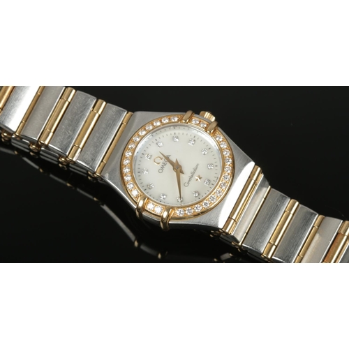 609 - A ladies Omega bi metal Constellation quartz wristwatch. With diamond set bezel and satin dial. Diam... 