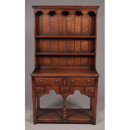 305 - A Titchmarsh & Goodwin oak kitchen dresser of small proportions. (162cm x 92cm x 36cm)