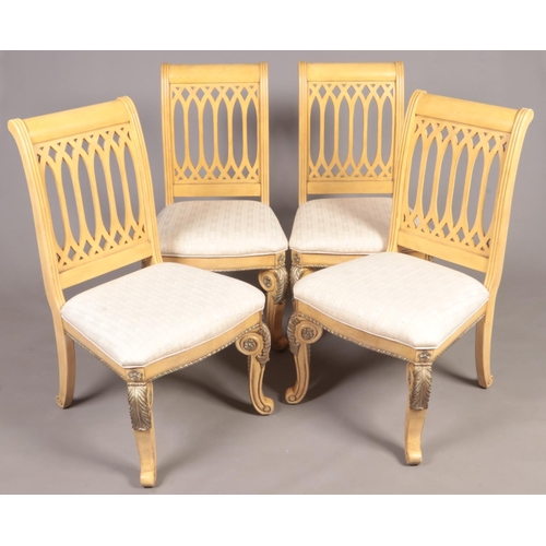 307 - A set of 4 good quality modern hardwood chairs raised on gilt moulded decorated supports.