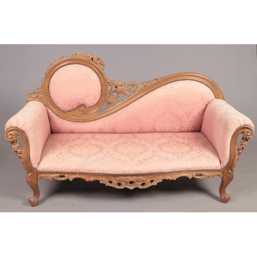 308 - A French style 2 seat parlour sofa with ornate carved wood decoration.