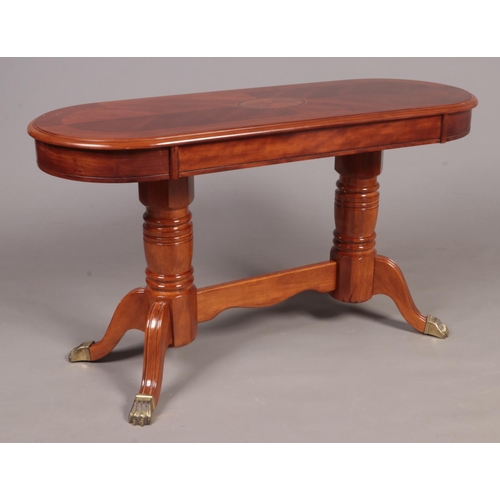 311 - A modern mahogany oval side table decorated with fan patera motif. (123cm x 68cm x 46cm)