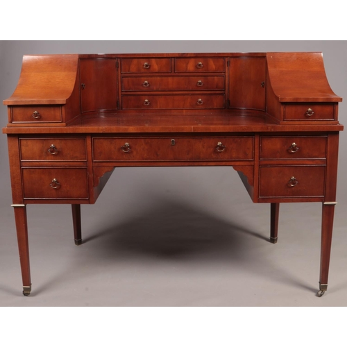 313 - A Hekman mahogany Carlton House writing desk with an arrangement of drawers and cupboards. (103cm x ... 