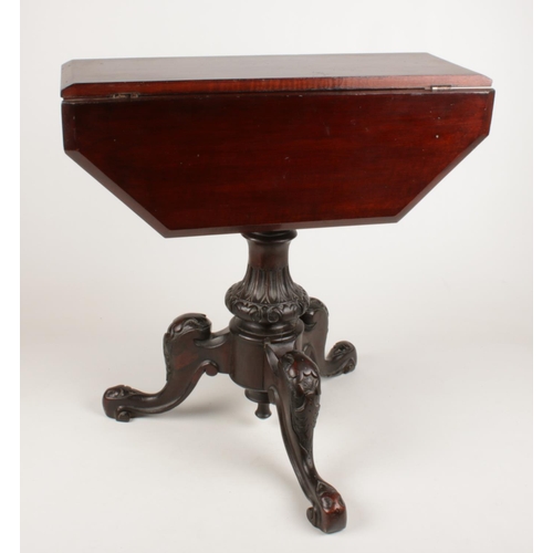 323 - A small mahogany drop leaf occasional table with ornate carved base.