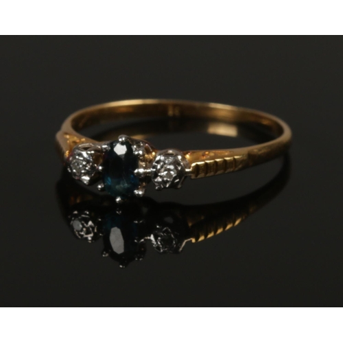 241 - An 18ct gold diamond and sapphire ring. Size R. 2.37g.