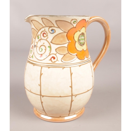 283 - A Bursley Ware Trellis jug, designed by Chrlotte Rhead. (15cm).