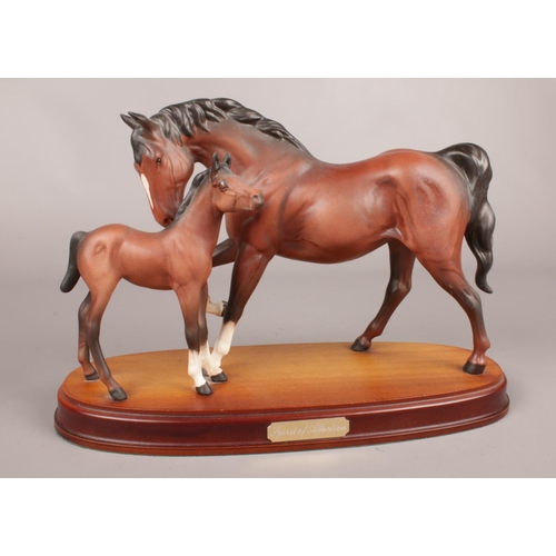 289 - A Royal Doulton figure 'Spirt of Affection' Mare & Foal on a wooden plinth. H: 21cm, W: 32cm.