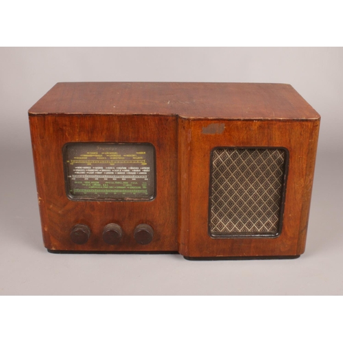 368 - A Seymour 1940's vintage wooden cased valve radio. 24.5 cm height, 44cm width, 23cm depth.