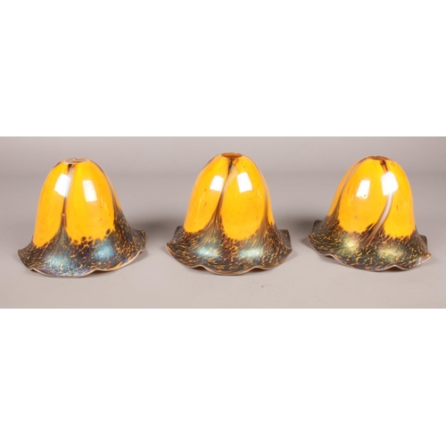 372 - Three Art Nouveau iridescent glass lamp shades. (17cm height)