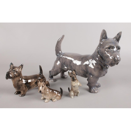 135 - A collection of ceramic Scottish Terrier dogs. Includes three Royal Doulton and one Royal Copenhagen... 