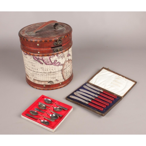 100 - A decorative storage box and cased silver plate cutlery, butter knives & teaspoons.