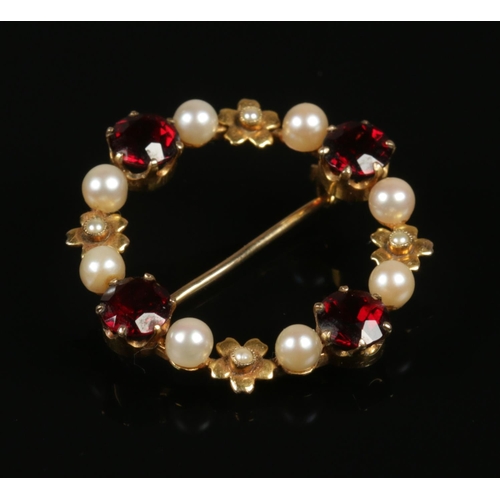 254 - A 9ct gold, garnet and pearl brooch.