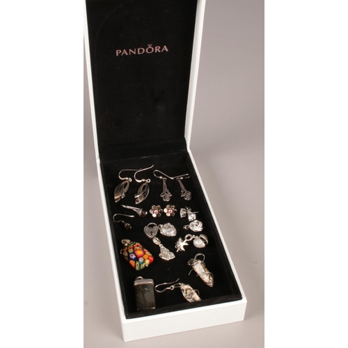 276 - A Pandora box with contents of silver pendants, charms and earrings.