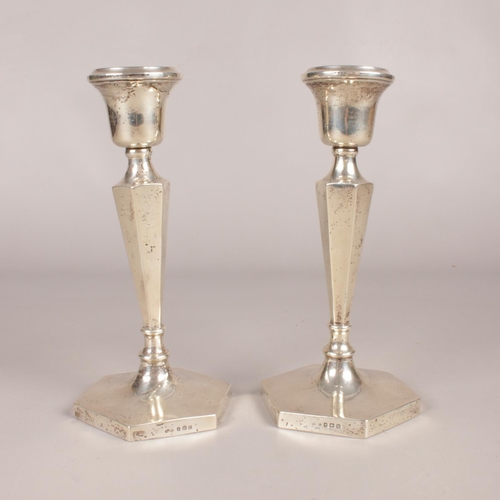 292 - A pair of silver hexagonal based candlesticks. Assayed in Birmingham 1919. Height: 21cm. Width: 10.5... 