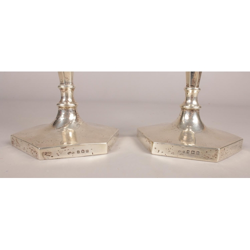 292 - A pair of silver hexagonal based candlesticks. Assayed in Birmingham 1919. Height: 21cm. Width: 10.5... 