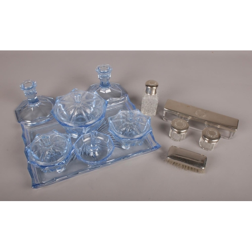 97 - A Ladies and Gents Dressing Table Set. Comprising of a blue glass tray with three various sized lidd... 