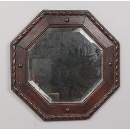 198 - An octagonal framed bevel edge wall mirror.