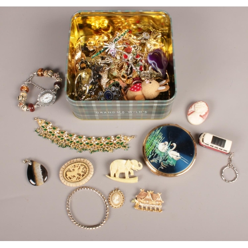 107 - A box of costume jewellery. Including Cameo brooch, compact, bracelets, etc.