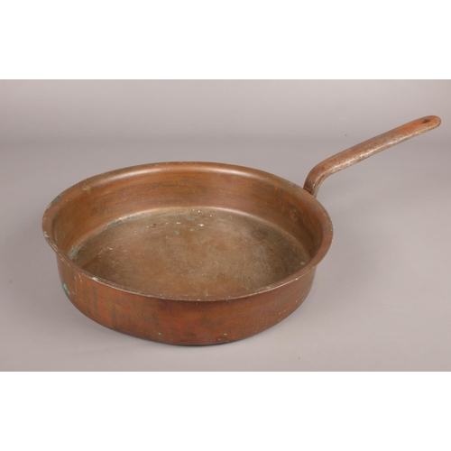 115 - A long handled copper pan.