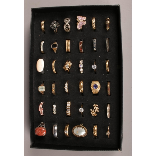 131 - 36 dress rings in display case.