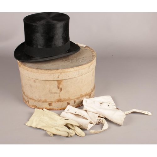 143 - A Dunn & Co London, moleskin / silk top hat. in its original box, to include wooden millinery hat st... 