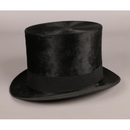 143 - A Dunn & Co London, moleskin / silk top hat. in its original box, to include wooden millinery hat st... 