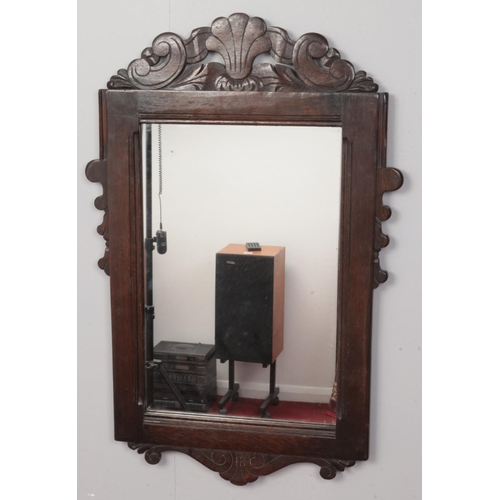 172 - A carved oak wall mirror. (Just Mirror, 52cm x 34cm)