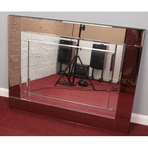 183 - A multi glass beveledge wall mirror with coloured glass border.