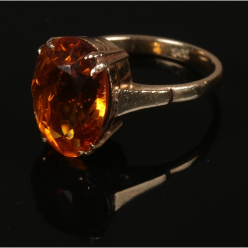 210 - A 9ct gold ring set with large faceted citrine stone. Size M.