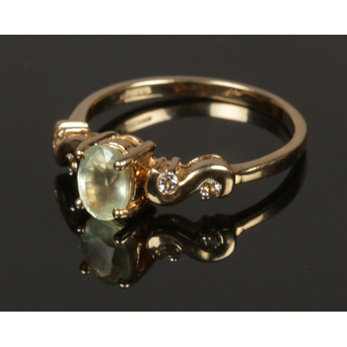 211 - A 9ct gold ring set with paste stones. Size O.