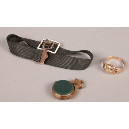 219 - Three pieces of gold and yellow metal jewellery oddments. Including 9ct gold mounted fob, bracelet w... 